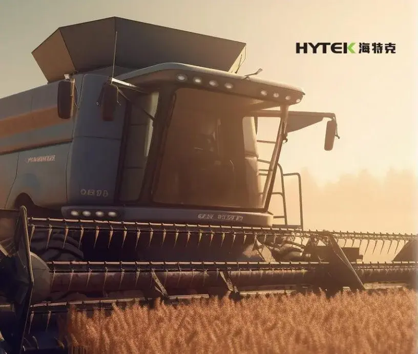 Combine harvester at work in a wheat field, equipped with Hytek hydraulic pumps and motors